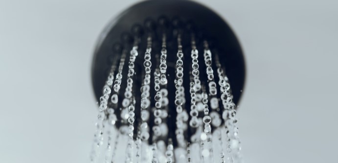 Showerhead with water coming out of it.